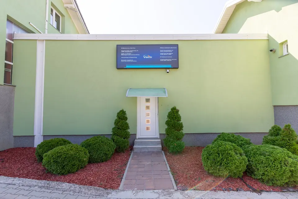 Entrance to the meeting room building with an LED screen above the door